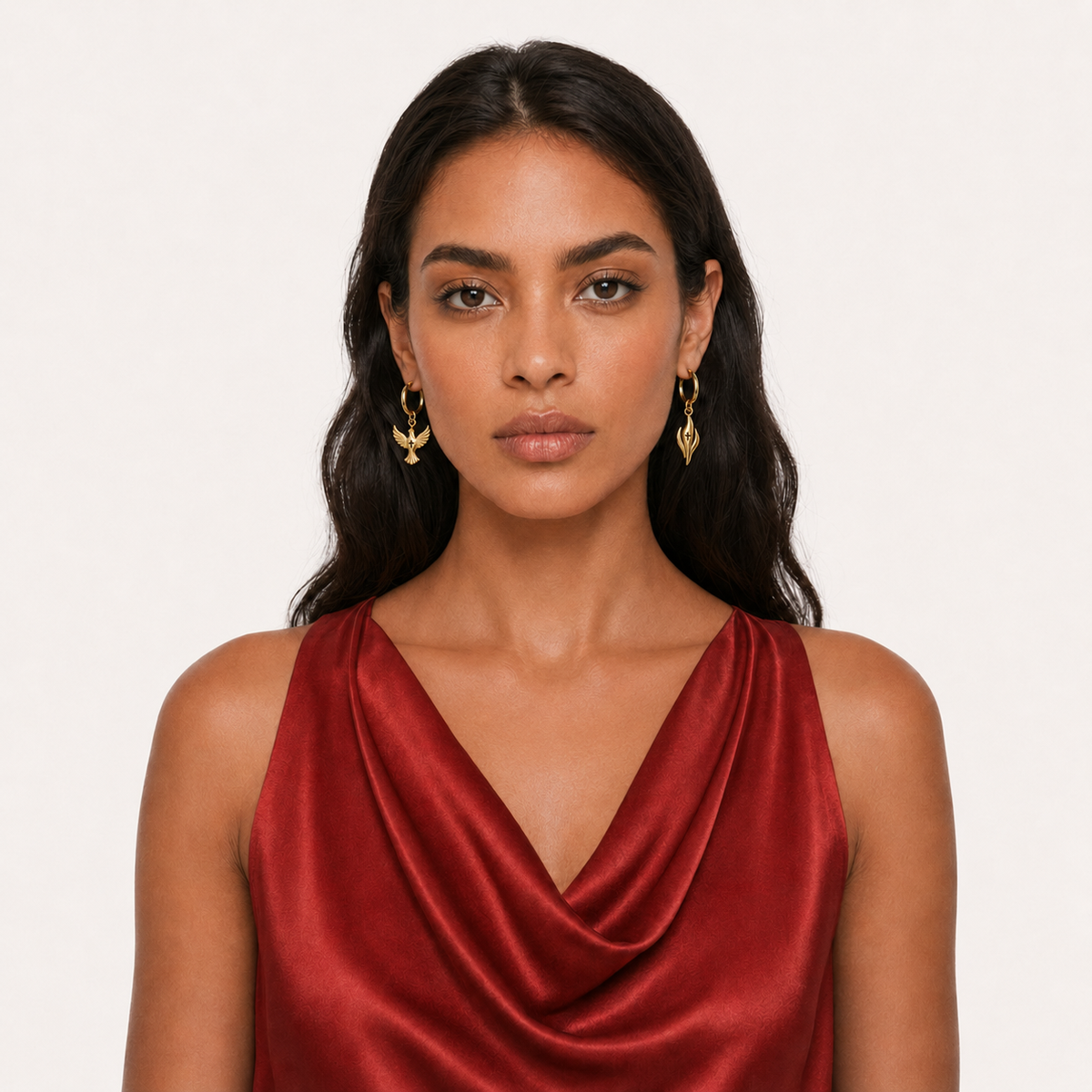 Model in a red dress wearing gold Relic earrings